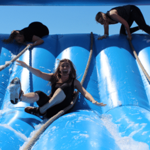 Participants enjoying an inflatable obstacle course at One Avenue Group's Weekend Getaway 2019