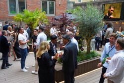 People socialising at an outdoor gathering on Cannon Street